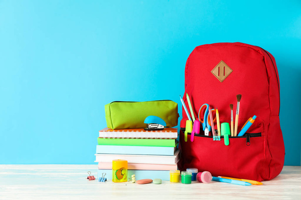 School supplies on wooden table against color background, space  - Foto, Bild