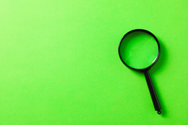 Magnifier on green background, space for text - Foto, imagen