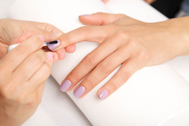 Manicure - Beautiful manicured woman's nails with violet nail po - Photo, Image