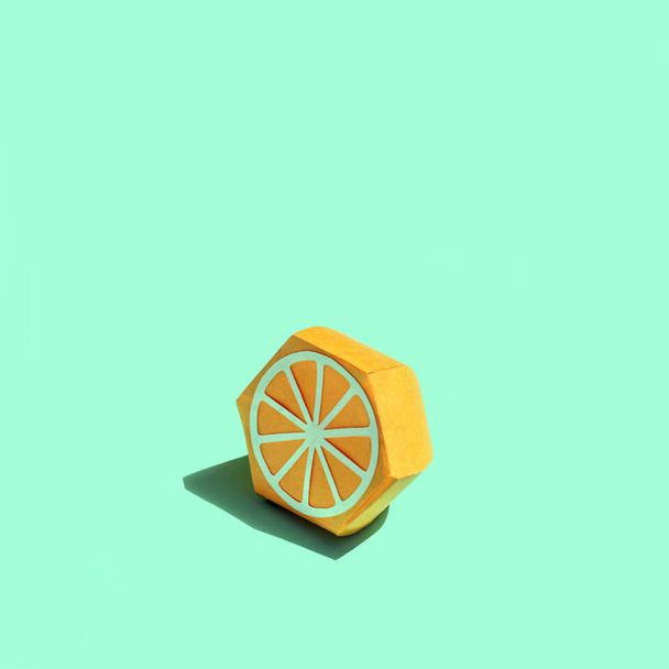 Paper half orange in bright sunshine  - Фото, изображение