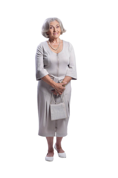 Happy senior woman wearing light dress posing isolated on white background - Photo, Image