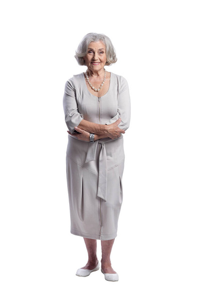 Happy senior woman wearing light dress posing isolated on white background - Foto, afbeelding