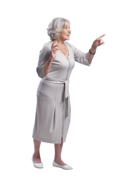 Smiling senior woman pointing isolated on white background - Photo, image