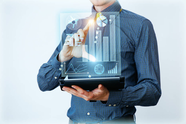 Businessman interacts with virtual screen, analyze data. Innovation Graphs Interfaces. - Photo, Image