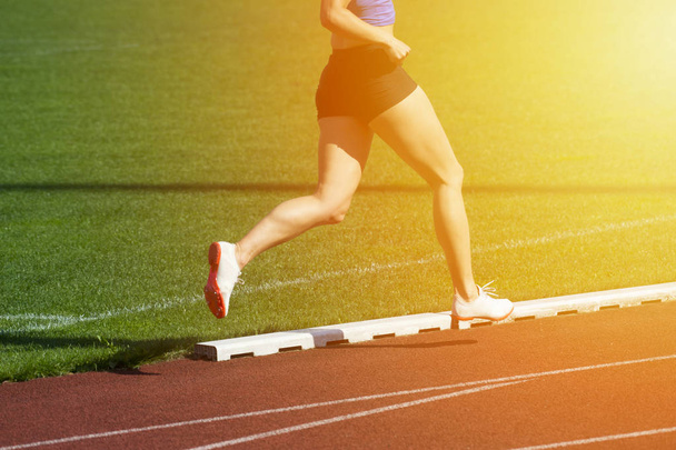 Athletics woman running on the track field - Photo, Image