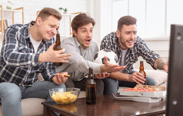 Disappointed friends watching football game, upset about loss - Photo, Image