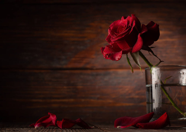 Red rose in vase on old wooden background, Vintage style - Foto, Bild
