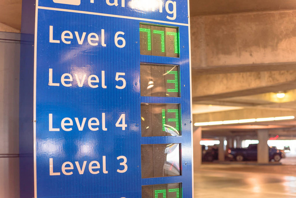 Smart signboard with available spots for each level at parking garage in American airport - Photo, Image