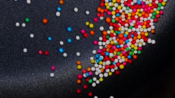 Värikäs sokeri pallo hidastettuna abstrakti tausta
 - Materiaali, video