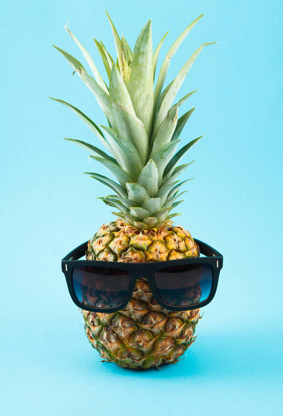 Fresh ripe pineapple on blue background - 写真・画像