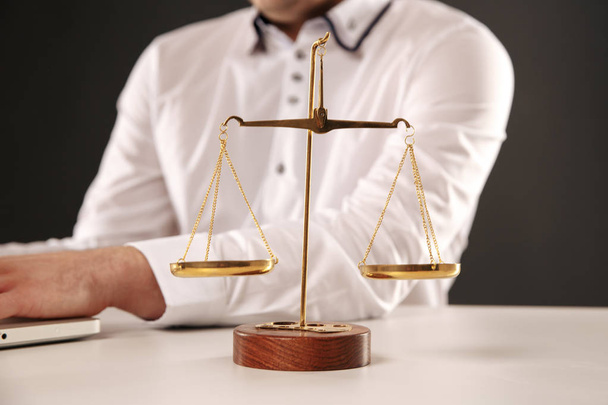 Weight scale of justice and mans hands on the background. - Photo, Image
