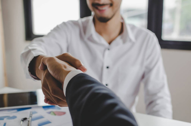 Partnership. two business people shaking hand after business signing contract in meeting room at company office, job interview, investor, success, negotiation, partnership, teamwork, financial concept - Foto, Bild