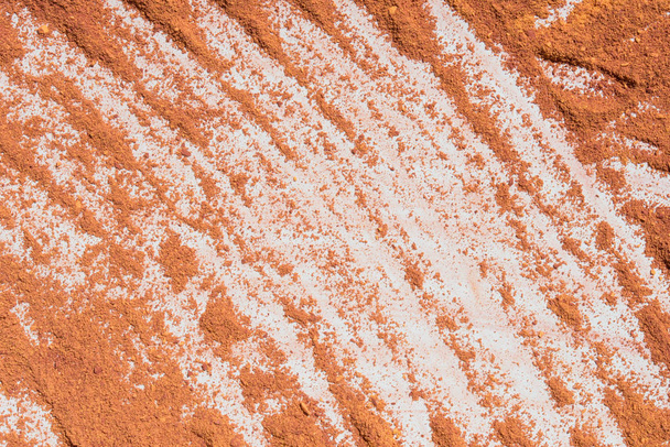 Oranje poeder pigment patroon achtergrond  - Foto, afbeelding