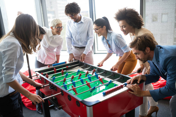 Coworkers playing table football and ralaxing on break from work - Fotografie, Obrázek
