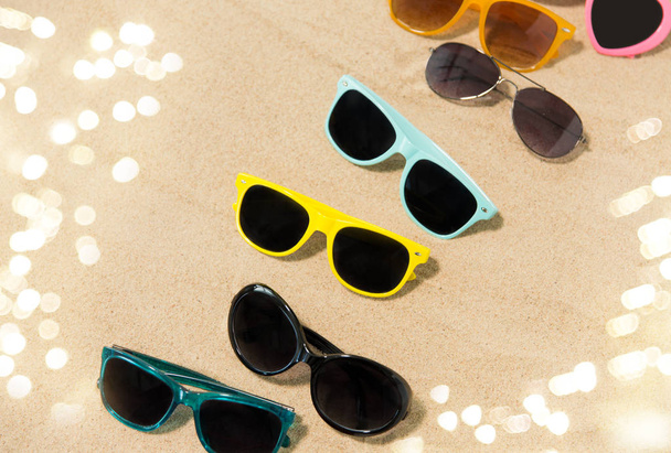 different sunglasses on beach sand - Foto, Imagem