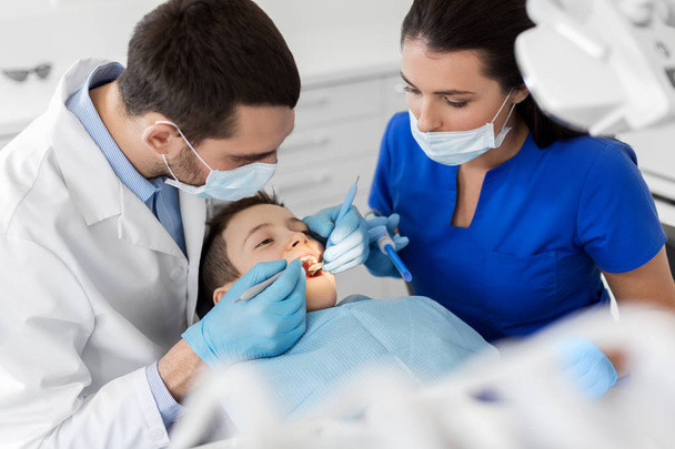 dentist checking for kid teeth at dental clinic - 写真・画像