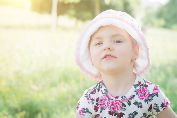 Photo of smiling little child girl in the park - Fotografie, Obrázek