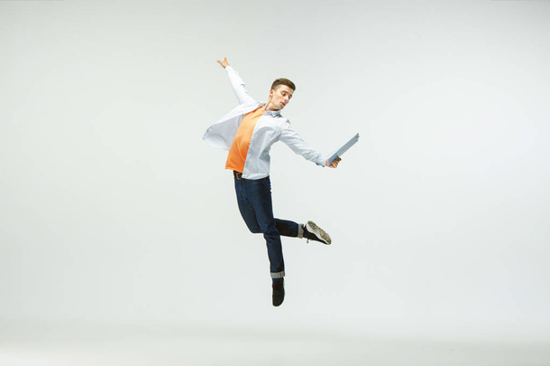 Office worker jumping isolated on white studio background - Foto, imagen