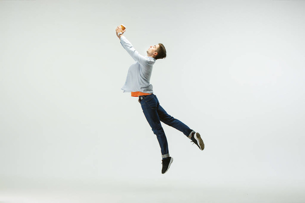 Office worker jumping isolated on white studio background - Fotó, kép