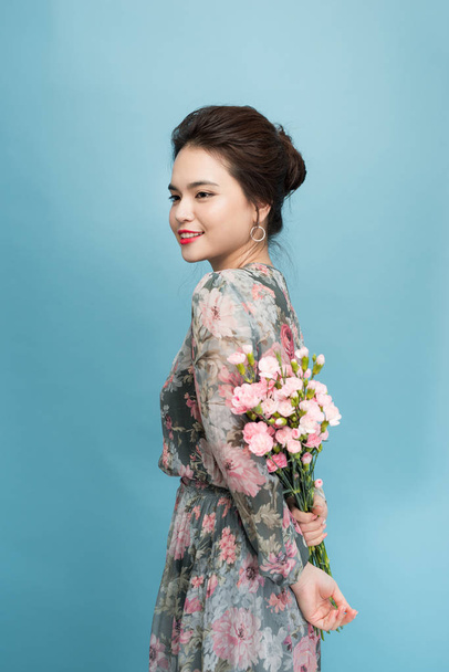 Beautiful portrait of pretty woman with flower bouquet, fashion make up, elegant dress - Photo, Image