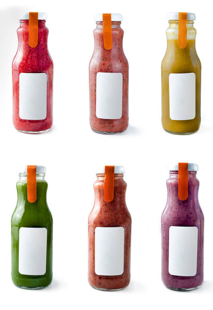 Set with color smothies in glass bottles with copy space on white background, mock-up - Foto, Bild