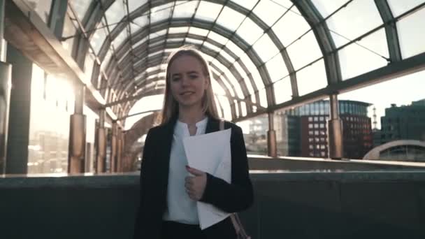 Portrait of young beautiful business woman or student in suit. She smiling, happy, standing at city center. Concept: new business, communication, banker, manager - Video