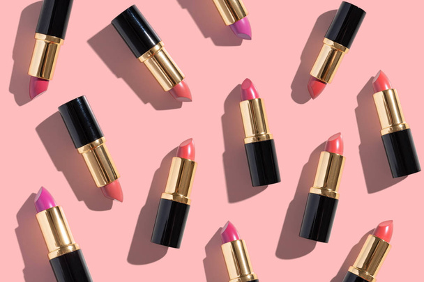 Set of color lipsticks on pink background. Flat lay. - Фото, изображение