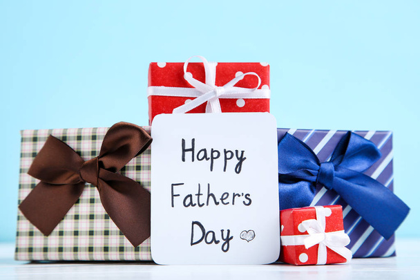 Text Happy Fathers Day with gift boxes on blue background - Foto, Bild