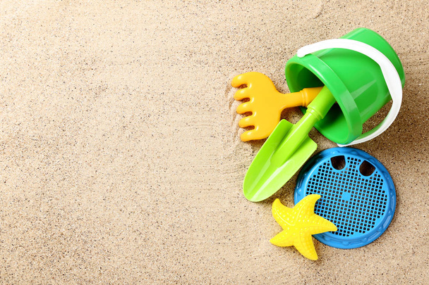 Plastic toys on beach sand - Фото, изображение