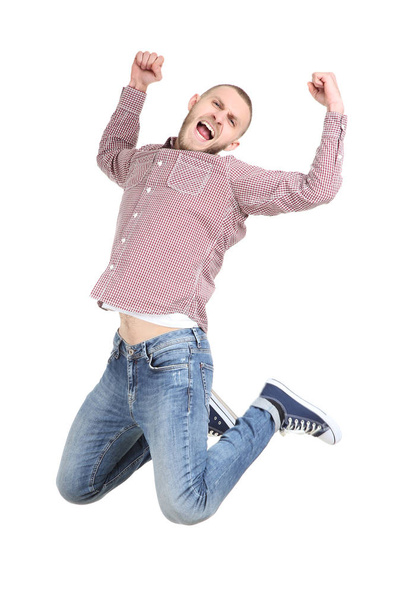 Jumping young man on white background - Foto, Bild