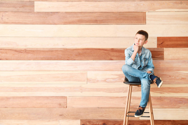 Stylish boy in jeans clothes near wooden wall - Photo, Image