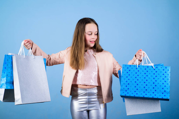 Clothing store. Sales and discounts. Holiday purchase saving. Small girl with shopping bags. Kid fashion. shop assistant with package. Happy child. Little girl with gifts. Clothing store concept - Photo, image