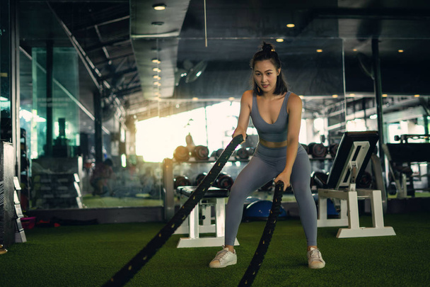 Donna con battaglia corda battaglia corde esercizio in palestra fitness
. - Foto, immagini