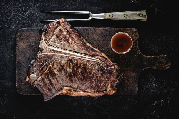 Grilled Dry Aged T-bone Steak on Vintage Cutting Board - Фото, зображення