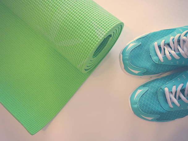 Зеленый коврик для йоги с видом сверху изолирован белым. Copyspace
.  - Фото, изображение