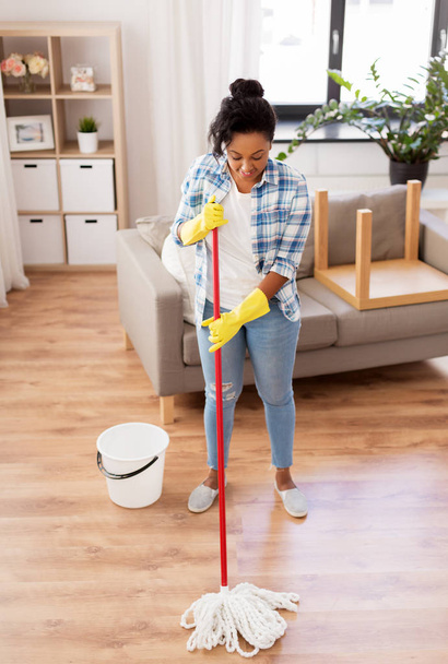 african woman or housewife cleaning floor at home - Foto, Imagen