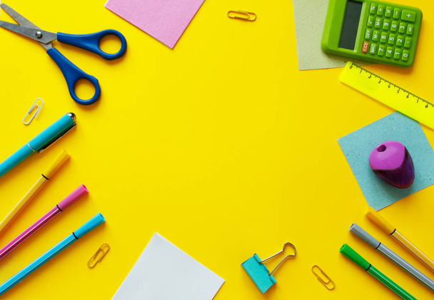 chool office supplies.Creative desk with colourful stationery. Colored paper clip.School supplies on yellow background.Office desk. - Photo, Image