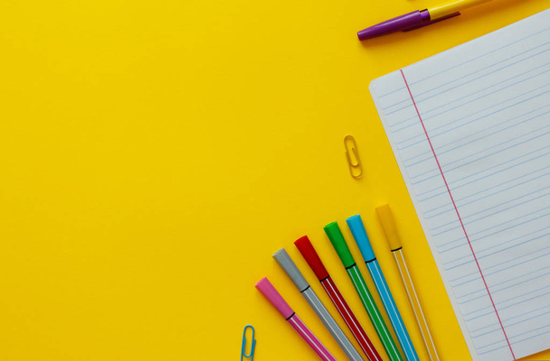 Back to school concept with space for text. Top view. Copy space. School office supplies.Creative desk with colourful stationery. Colored paper clip.School supplies on yellow background.Office desk. - Photo, Image