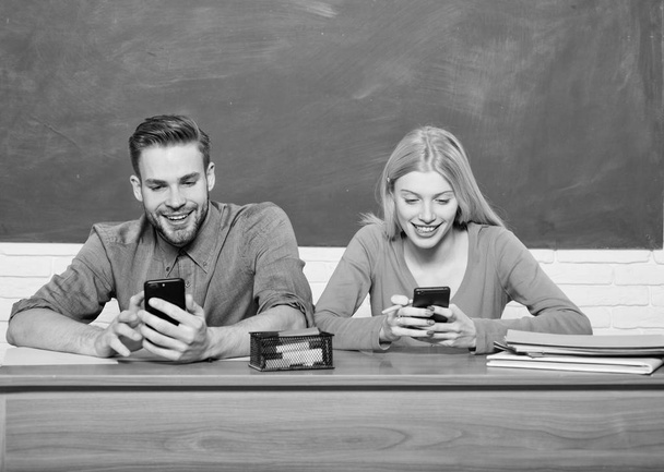 Digital world. Home schooling. Couple of man and woman in classroom. Back to school. Modern school. Knowledge day. Student life. Lesson and blackboard. Teachers day. Happy couple - Фото, зображення