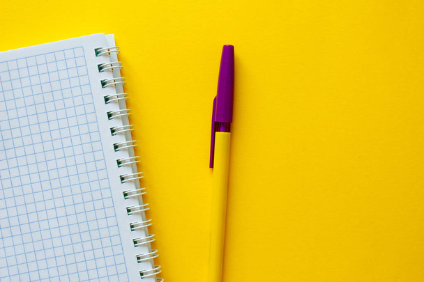 Colored paper clip.School supplies on yellow background.Office desk. - Fotoğraf, Görsel