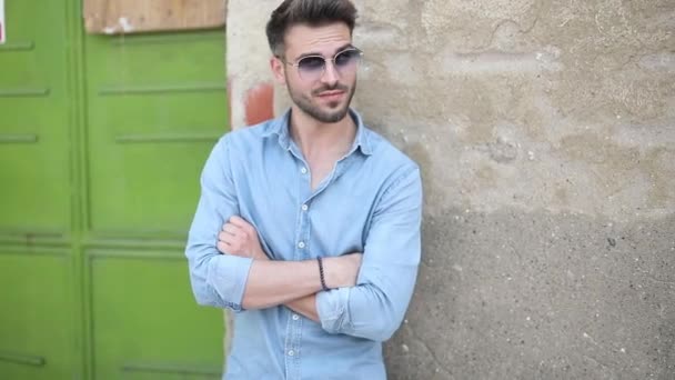 young casual man leaning against old building - Footage, Video