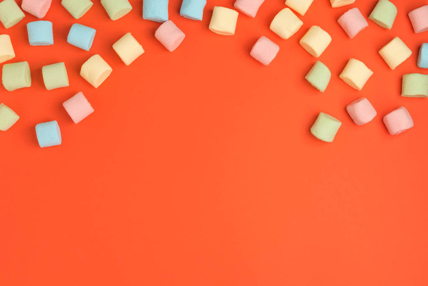 Coral paper background with marshmallow. Cozy sweet background - Zdjęcie, obraz