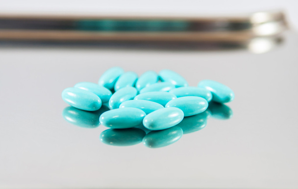 Blue tablet on dispensing metal tray - Photo, Image
