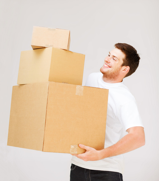 Young man carrying carton boxes - Foto, imagen