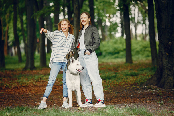 Elegant and stylish girls in a summer forest - Foto, afbeelding