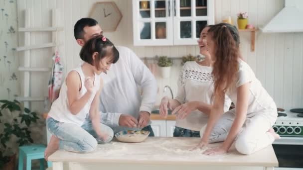 Happy family throw flour to each other, have fun time at kitchen, slow motion - Video, Çekim