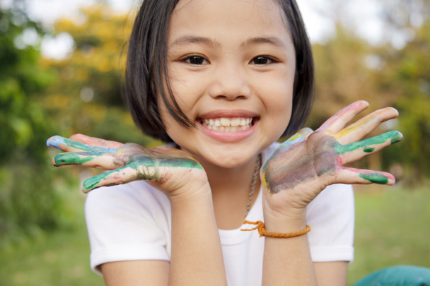 Asian little girl with hands painted in colorful paints - Photo, Image
