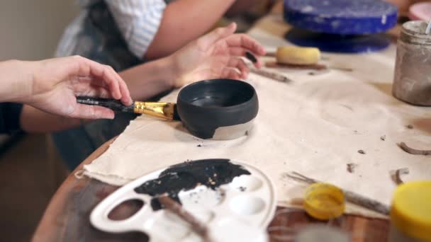 Decorating clay mug in a workshop. - Footage, Video