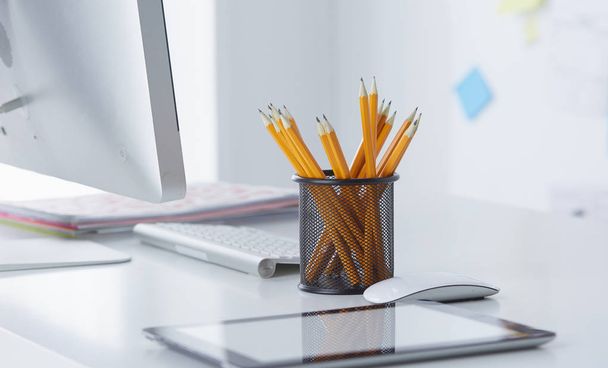 Graphite pencils in a glass cup on the office table. Concept. - Photo, Image