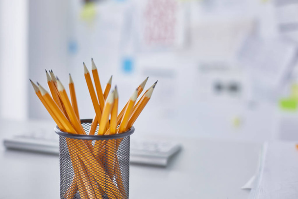 Graphite pencils in a glass cup on the office table. Concept. - Fotografie, Obrázek